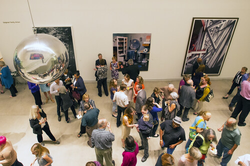 A group of people gathered in the Museum atrium.